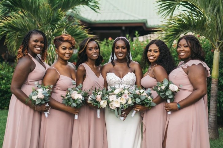 bridal party wearing flowy pink and blush Azazie bridesmaids dresses online