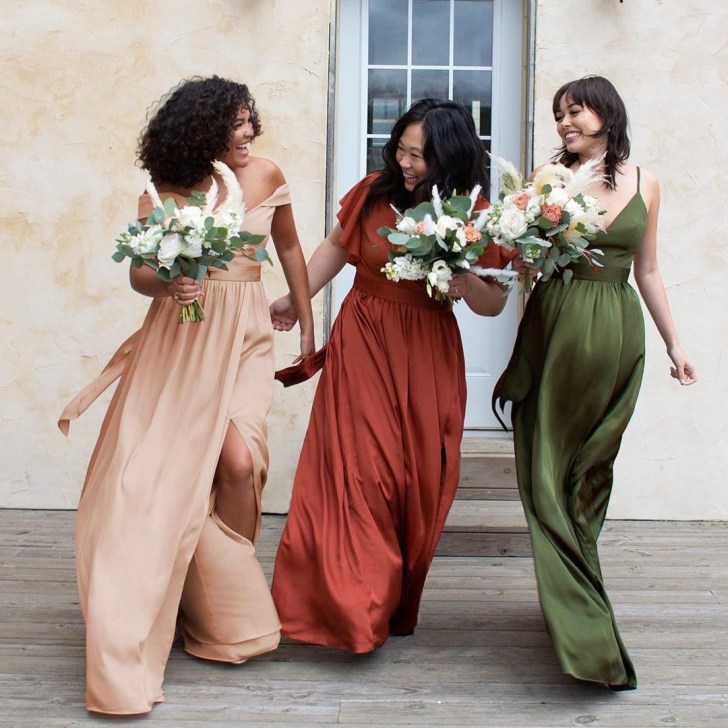 bridal party holding bouquets and walking together while wearing David's Bridal online bridesmaids dresses