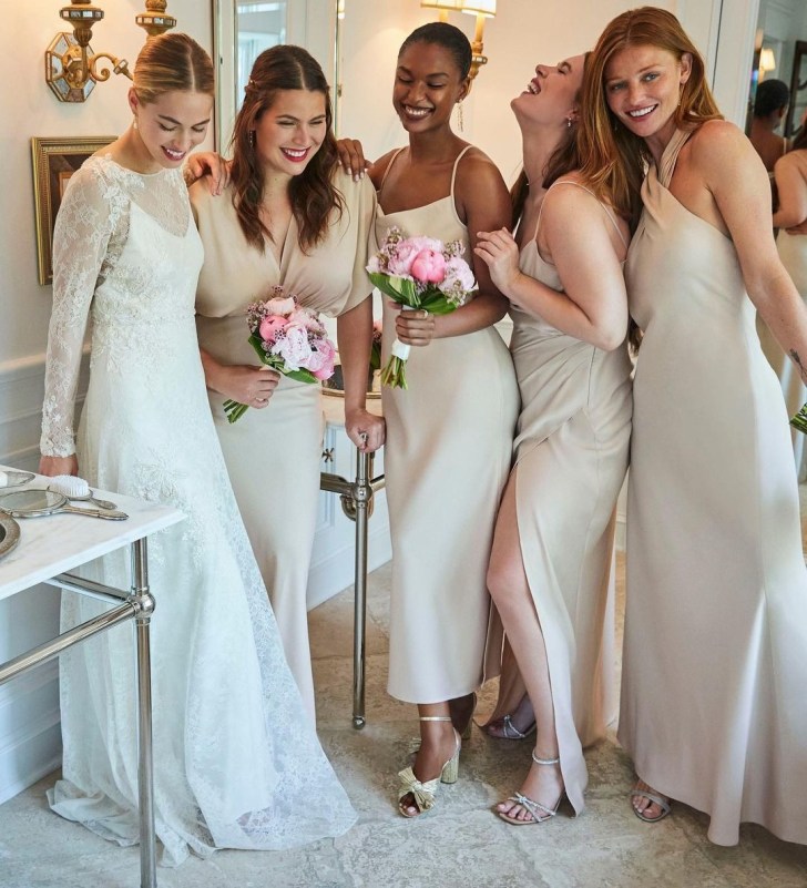 bridal party wearing different style neutral tone bridesmaid dresses online from BHLDN
