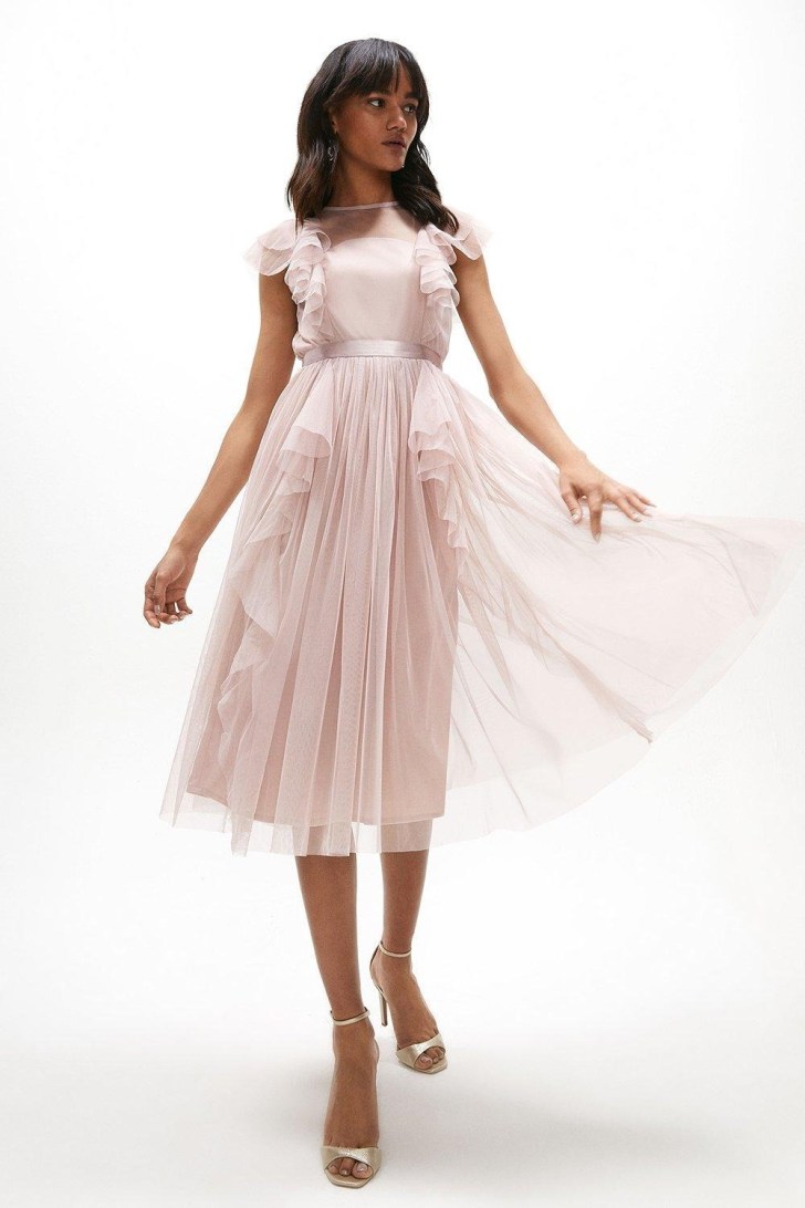 woman wearing a light pink ruffle mesh pleated bridesmaid dress online from Coast