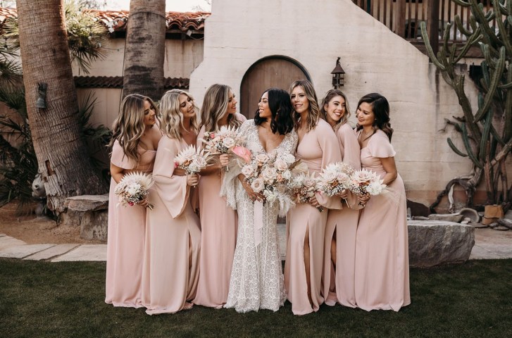 bridal party holding large floral bouquets while wearing light pink maxi length chiffon bridesmaid dresses online from Show Me Your Mumu