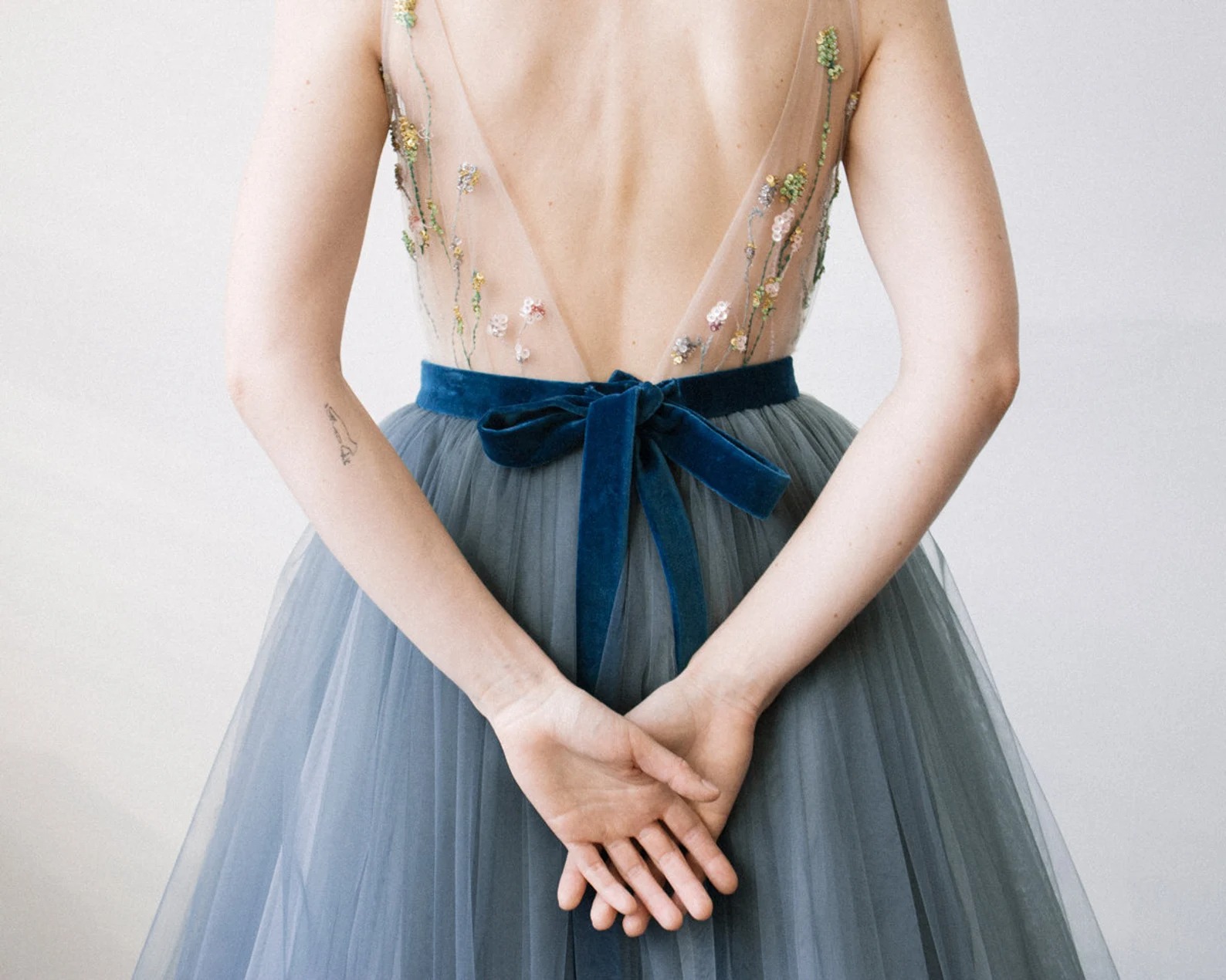 dusty blue tulle online wedding dress with a blue velvet ribbon around the waist