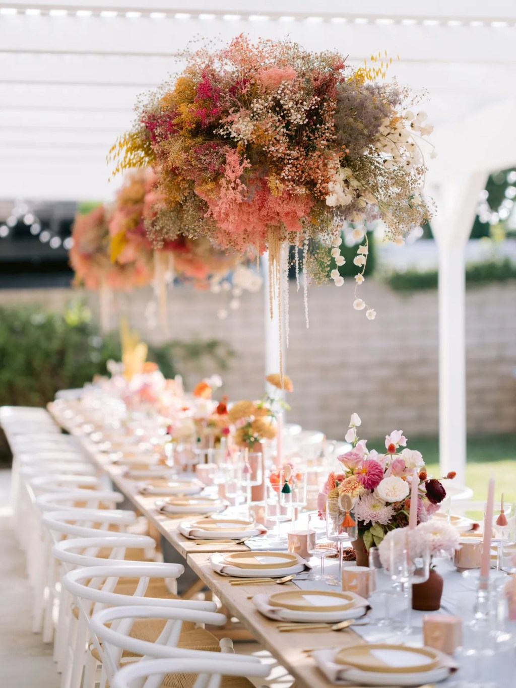 colorful al fresco dining bachelorette party ideas with dramatic floral installations