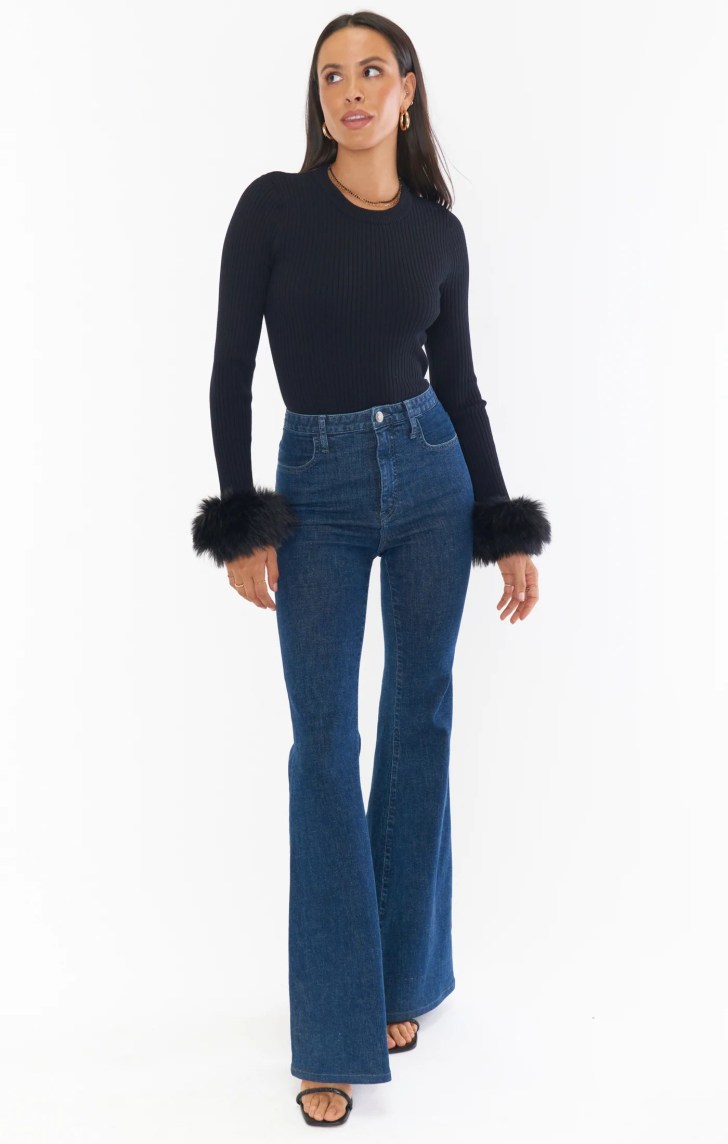 cute faux fur trimmed sweater and flare jeans best casual Christmas outfits for holiday party