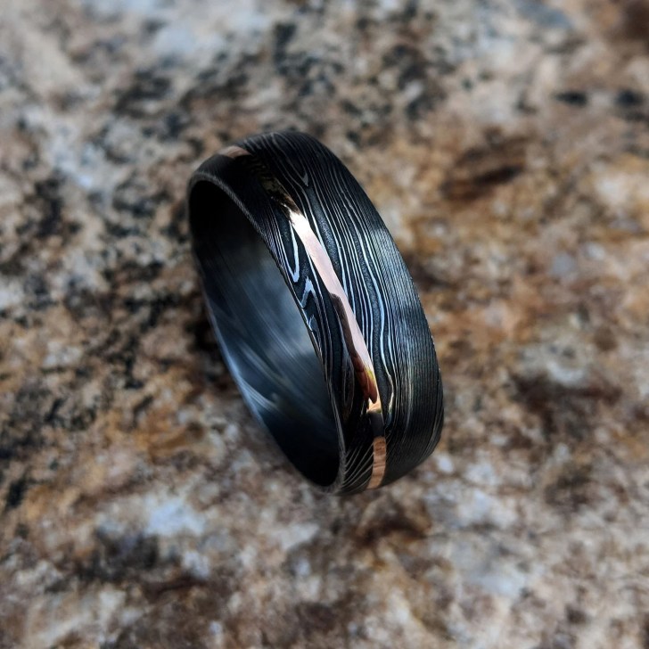 Damascus steel wedding ring for men with rose gold inlay