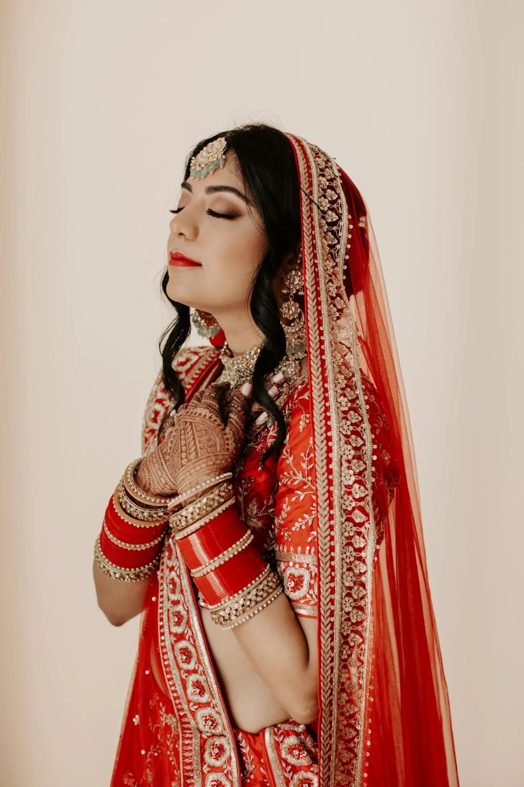 glam traditional Indian red wedding dresses with intricate nature inspired detailing