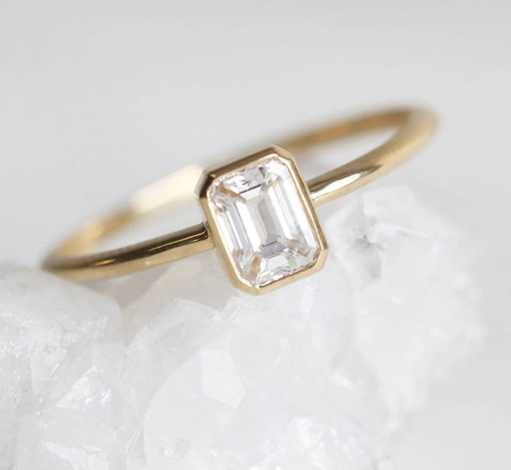 small minimalist gold bezel set diamond simple engagement rings