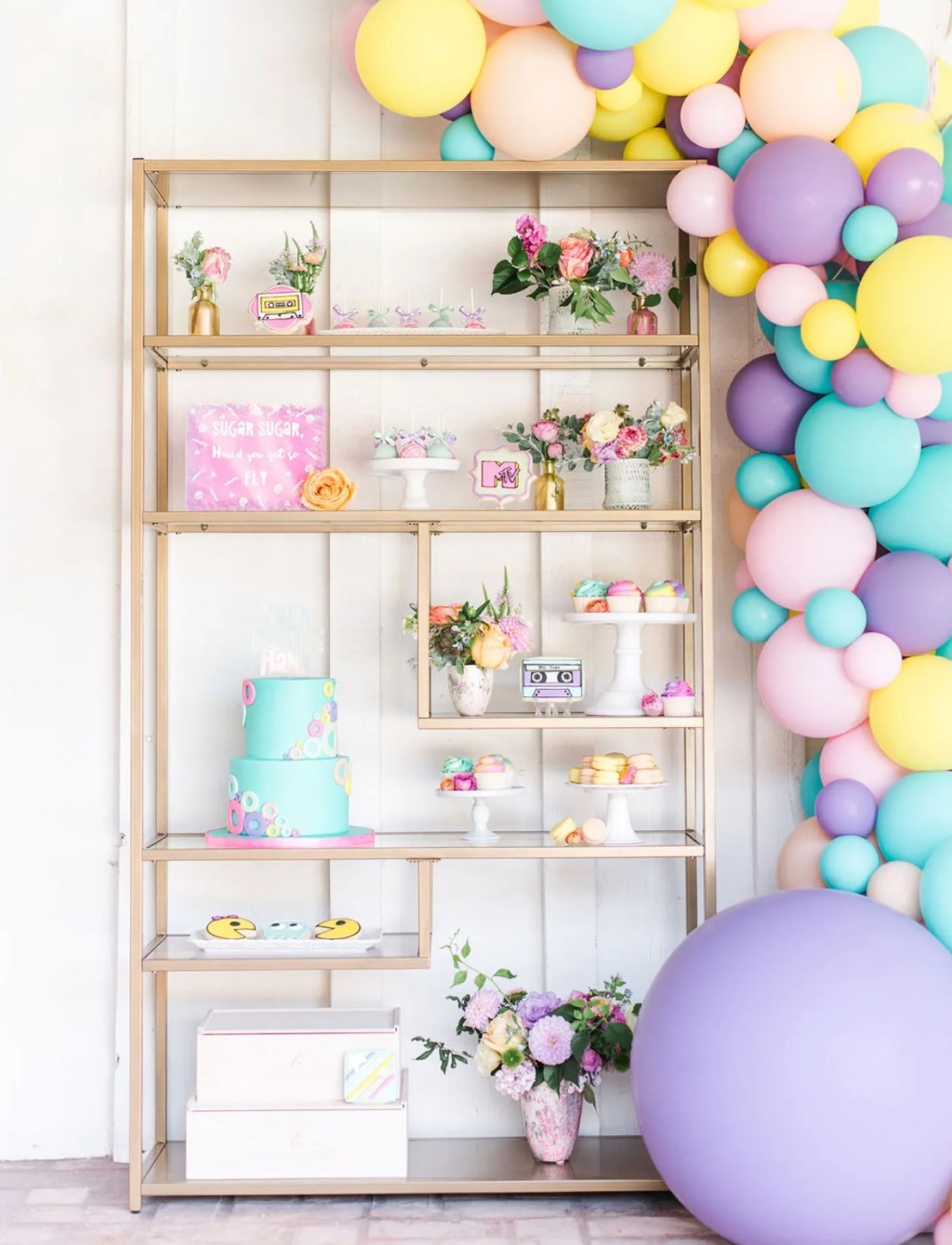 pastel 90's theme bachelorette party ideas with balloon arch