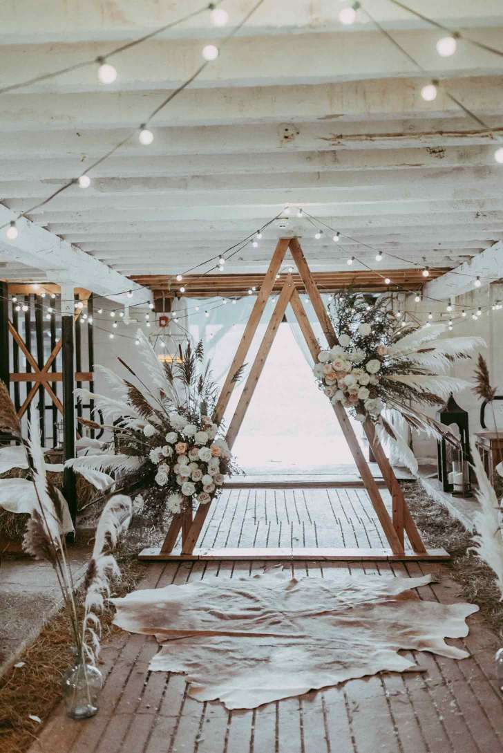 rustic double arch best Christmas wedding ideas with wood and floral elements