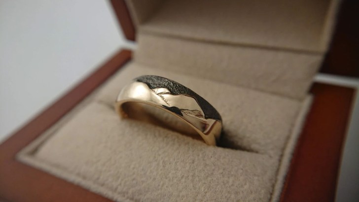unique gold mens wedding ring with mountain engraving