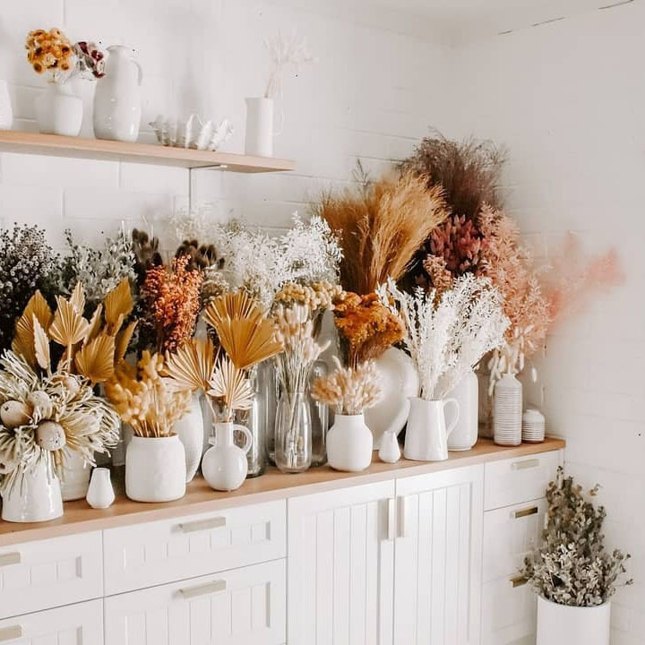 selection of dried flowers and dried flower bouquets placed in a collection on a shelf