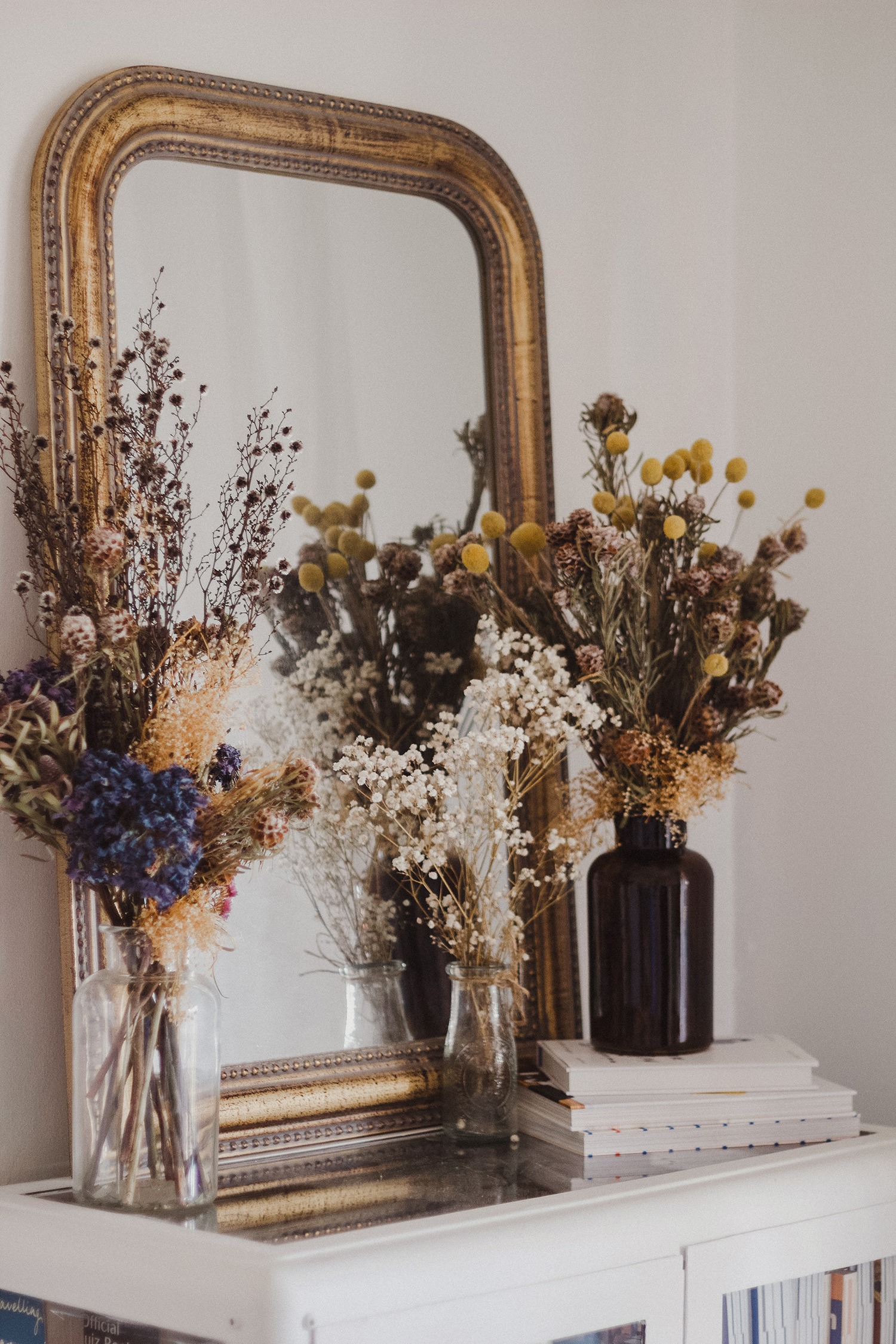 where to buy dried flowers online - bouquets of dried florals sitting in vases on a mantle