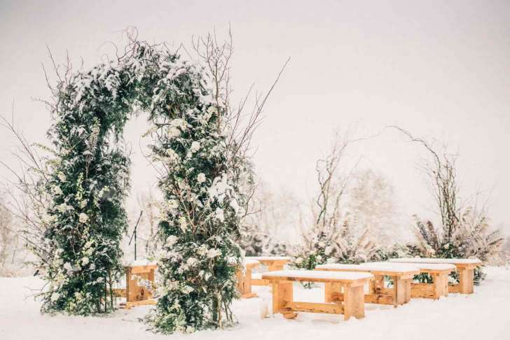 snowy winter wonderland greenery arch best Christmas wedding ideas