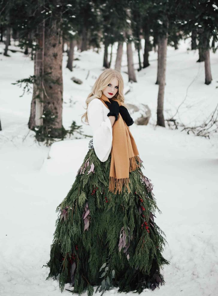 winter wonderland best Christmas wedding ideas where bride is wearing a real greenery garland skirt